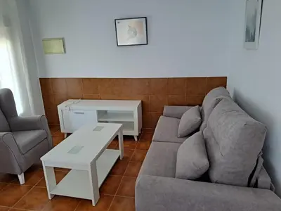 a living room with a couch and a table at Villa Encanto Chiclana in Novo Sancti Petri