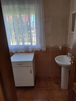 a bathroom with a sink and a toilet and a window at Villa Encanto Chiclana in Novo Sancti Petri