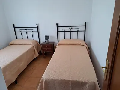 two beds sitting next to each other in a room at Villa Encanto Chiclana in Novo Sancti Petri