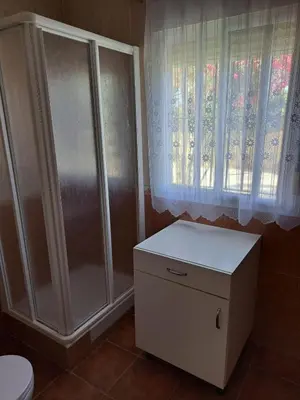 a bathroom with a shower and a toilet and a window at Villa Encanto Chiclana in Novo Sancti Petri