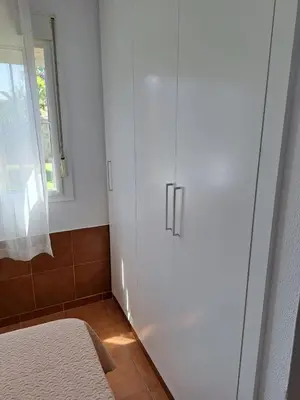 a white cabinet in a room with a window at Villa Encanto Chiclana in Novo Sancti Petri