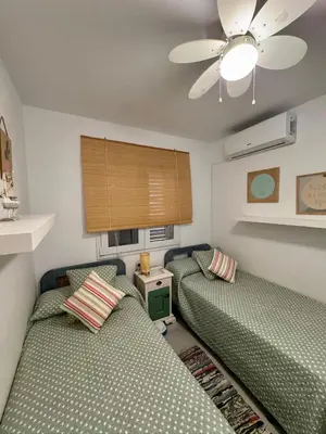 a bedroom with two beds and a ceiling fan at Precioso Adosado El Cormorán Novo Sancti Petri in Novo Sancti Petri