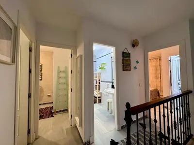 a hallway with a bathroom with a sink and a tub at Precioso Adosado El Cormorán Novo Sancti Petri in Novo Sancti Petri