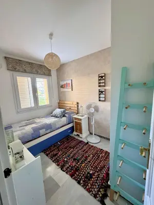 a bedroom with a bed and a rug at Precioso Adosado El Cormorán Novo Sancti Petri in Novo Sancti Petri