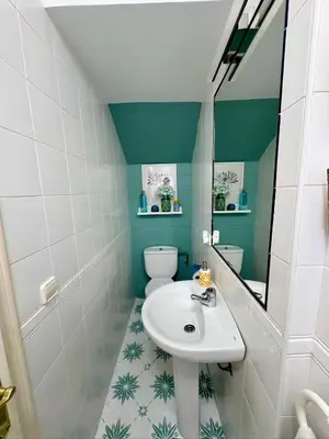 a bathroom with a sink and a toilet and a mirror at Precioso Adosado El Cormorán Novo Sancti Petri in Novo Sancti Petri
