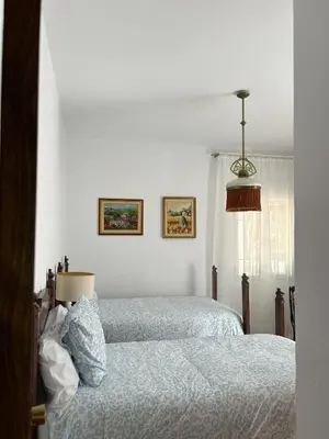 a bedroom with two beds and a window at Casa rural Pinar de la Plata in Arcos de la Frontera