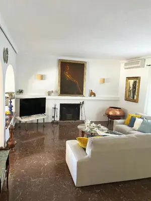 a living room with a couch and a fireplace at Casa rural Pinar de la Plata in Arcos de la Frontera