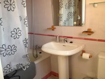 a bathroom with a sink and a shower curtain at Cerca del Mar in Novo Sancti Petri