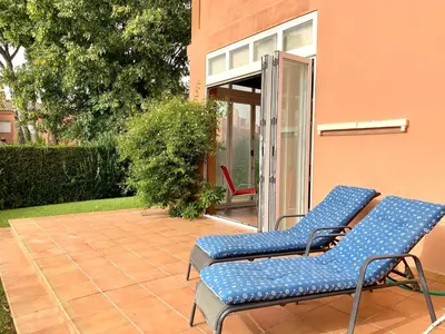 two blue chairs sitting on a patio at Cerca del Mar in Novo Sancti Petri