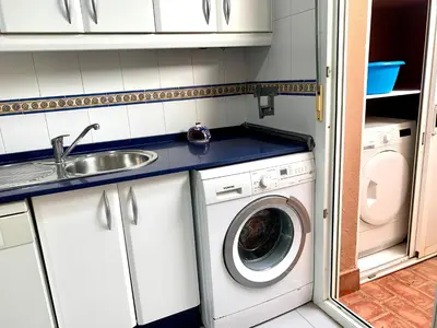 a small kitchen with a sink and a washing machine at Cerca del Mar in Novo Sancti Petri