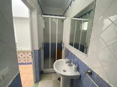 a bathroom with a sink and a mirror at El Descanso de Chipiona in Chipiona