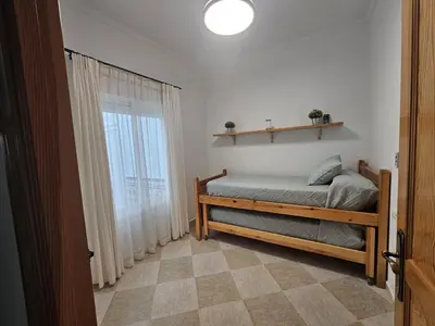 a bedroom with a bed and a window at El Descanso de Chipiona in Chipiona