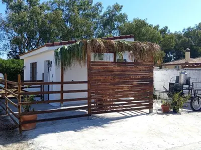 a wooden fence with a gate in front of a house at El Girasol yellowstone in Chiclana de la Frontera