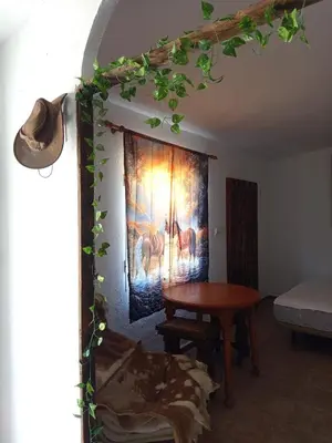 a room with a table and a painting on the wall at El Girasol yellowstone in Chiclana de la Frontera