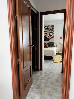 a hallway with an open door to a bedroom at El Piso in Sanlúcar de Barrameda