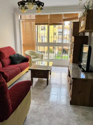 a living room with a couch and a coffee table at El Piso in Sanlúcar de Barrameda