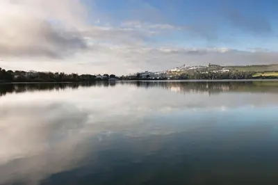 a large body of water with a city in the background at La Playita de Arcos in Arcos de la Frontera