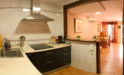 a kitchen with a sink and a stove at La Playita de Arcos in Arcos de la Frontera