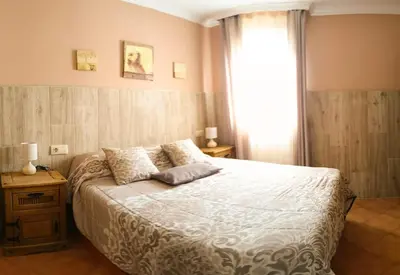 a bedroom with a large bed and a window at La Playita de Arcos in Arcos de la Frontera