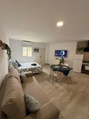 a living room with a couch and a table at Ático Bf Jerez in Jerez de la Frontera