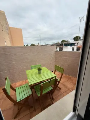 a green table and chairs on a balcony at Ático Bf Jerez in Jerez de la Frontera