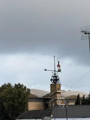 a building with a weather vane on top of it at Ático Bf Jerez in Jerez de la Frontera