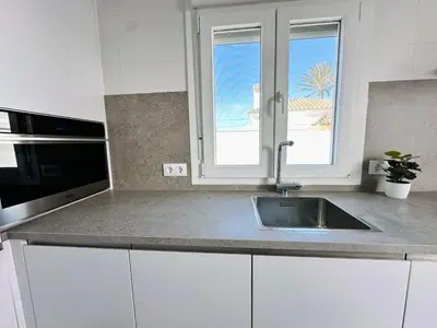 a kitchen counter with a sink and a window at Pradera Villa Encanto in Chiclana de la Frontera