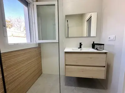 a bathroom with a sink and a mirror at Pradera Villa Encanto in Chiclana de la Frontera