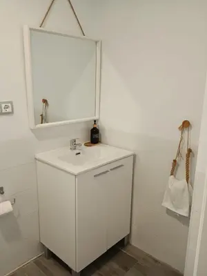 a white bathroom with a sink and a mirror at Plateros 4 in Jerez de la Frontera