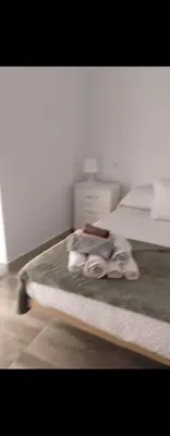 a bedroom with a bed with a towel on it at Plateros 4 in Jerez de la Frontera