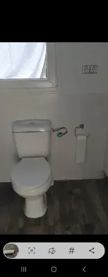 a white toilet in a bathroom with a window at Plateros 4 in Jerez de la Frontera