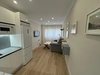 a kitchen and living room with a couch and a table at Mirador de Sanlucar 3 in Sanlúcar de Barrameda