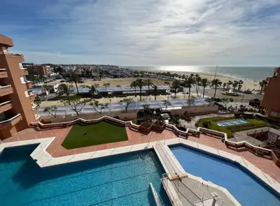 an aerial view of a resort with a swimming pool and the beach at Mirador de Sanlucar 3 in Sanlúcar de Barrameda