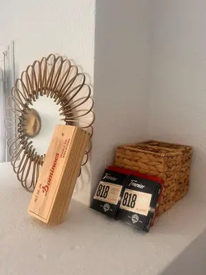 a shelf with a mirror and a book and a basket at Duplex Las Torres La Barrosa - 750m from the Beach in Novo Sancti Petri