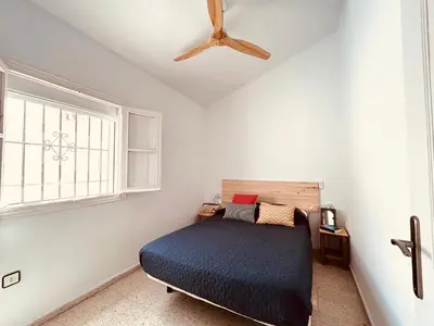 a bedroom with a bed and a ceiling fan at Duplex Las Torres La Barrosa - 750m from the Beach in Novo Sancti Petri