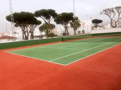 a tennis court with trees in the background at Duplex Las Torres La Barrosa - 750m from the Beach in Novo Sancti Petri