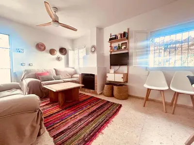 a living room with a couch and a table at Duplex Las Torres La Barrosa - 750m from the Beach in Novo Sancti Petri