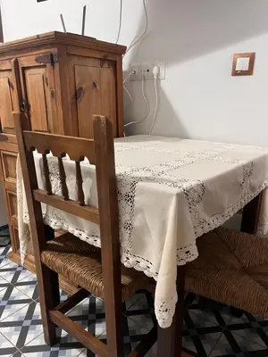 a dining room table with a white table cloth on it at El Patio de María 2 in Bornos