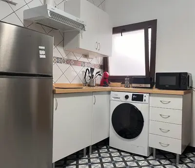 a kitchen with a stainless steel refrigerator and a dishwasher at El Patio de María 2 in Bornos