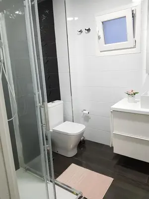 a bathroom with a toilet and a glass shower at Playa La Caleta in Cádiz