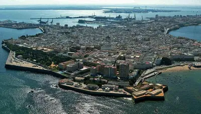 an aerial view of a city in the water at Playa La Caleta in Cádiz