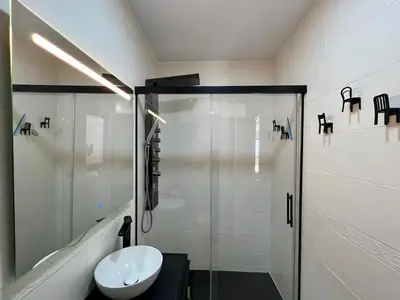 a bathroom with a glass shower and a sink at El Refugio in Chiclana de la Frontera