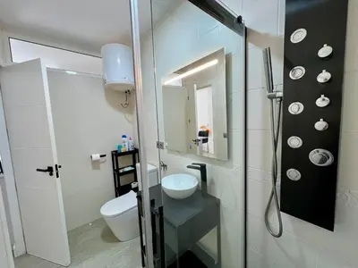 a bathroom with a shower and a toilet and a sink at El Refugio in Chiclana de la Frontera