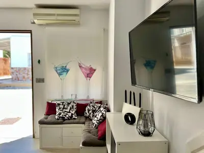 a living room with a couch and two wine glasses at El Refugio in Chiclana de la Frontera