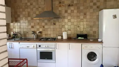 a kitchen with a refrigerator and a washing machine at Casa Toya in Arcos de la Frontera