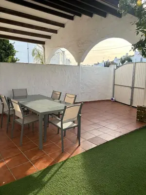 a patio with a table and chairs on a patio at La Barrosita in Chiclana de la Frontera
