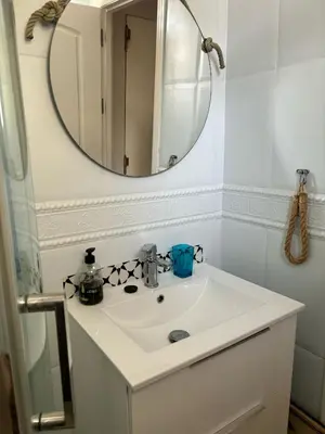 a bathroom with a white sink and a mirror at La Barrosita in Chiclana de la Frontera