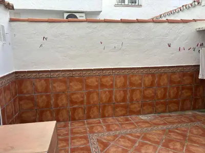 a tiled wall with a mural on it at La Barrosita in Chiclana de la Frontera