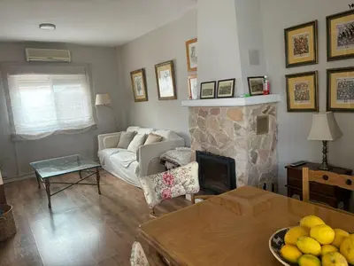 a living room with a couch and a fireplace at La Barrosita in Chiclana de la Frontera