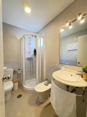 a bathroom with a shower toilet and a sink at Malandar Playa in Sanlúcar de Barrameda